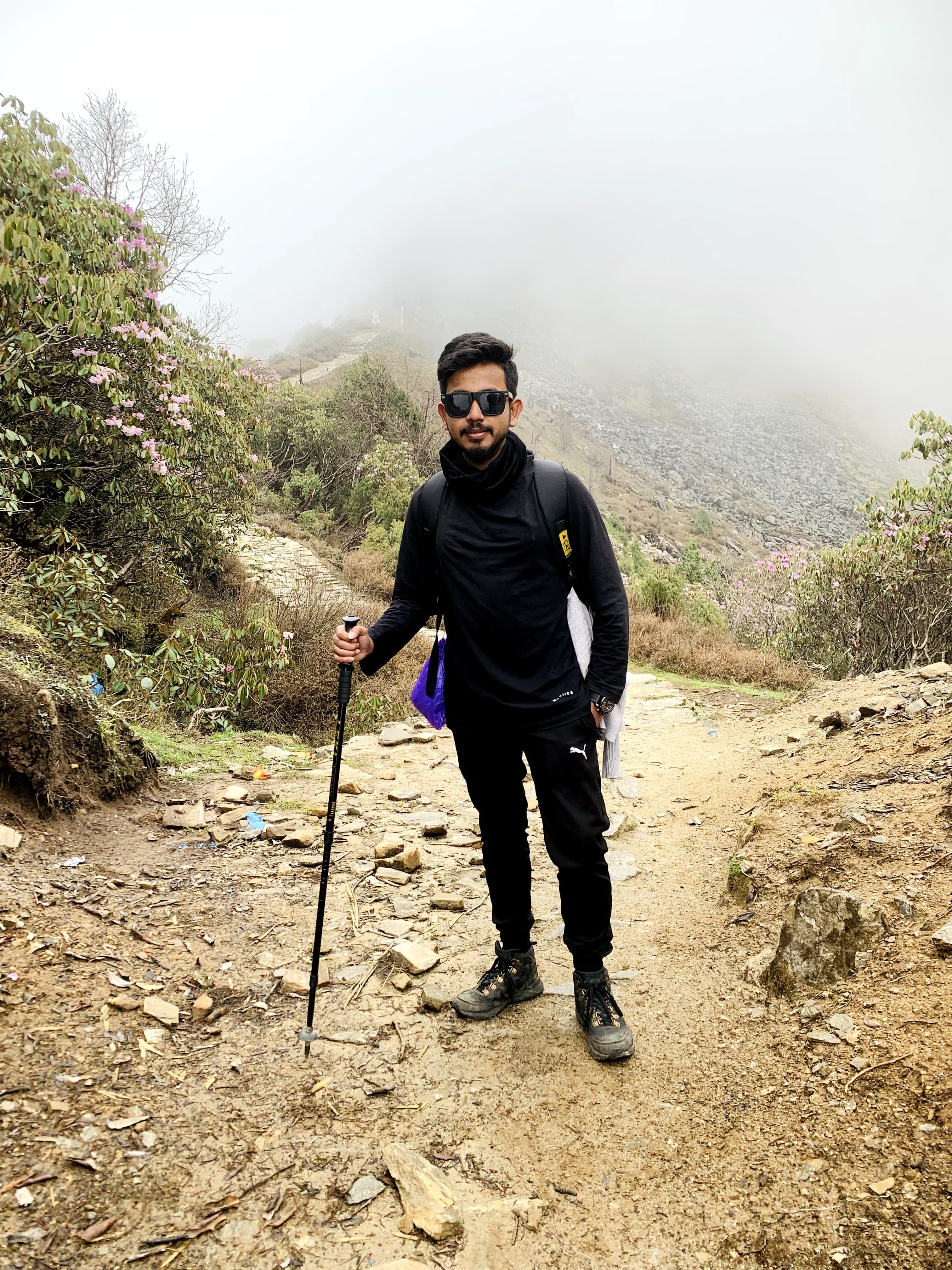 Trekking with friends on misty mountain trail