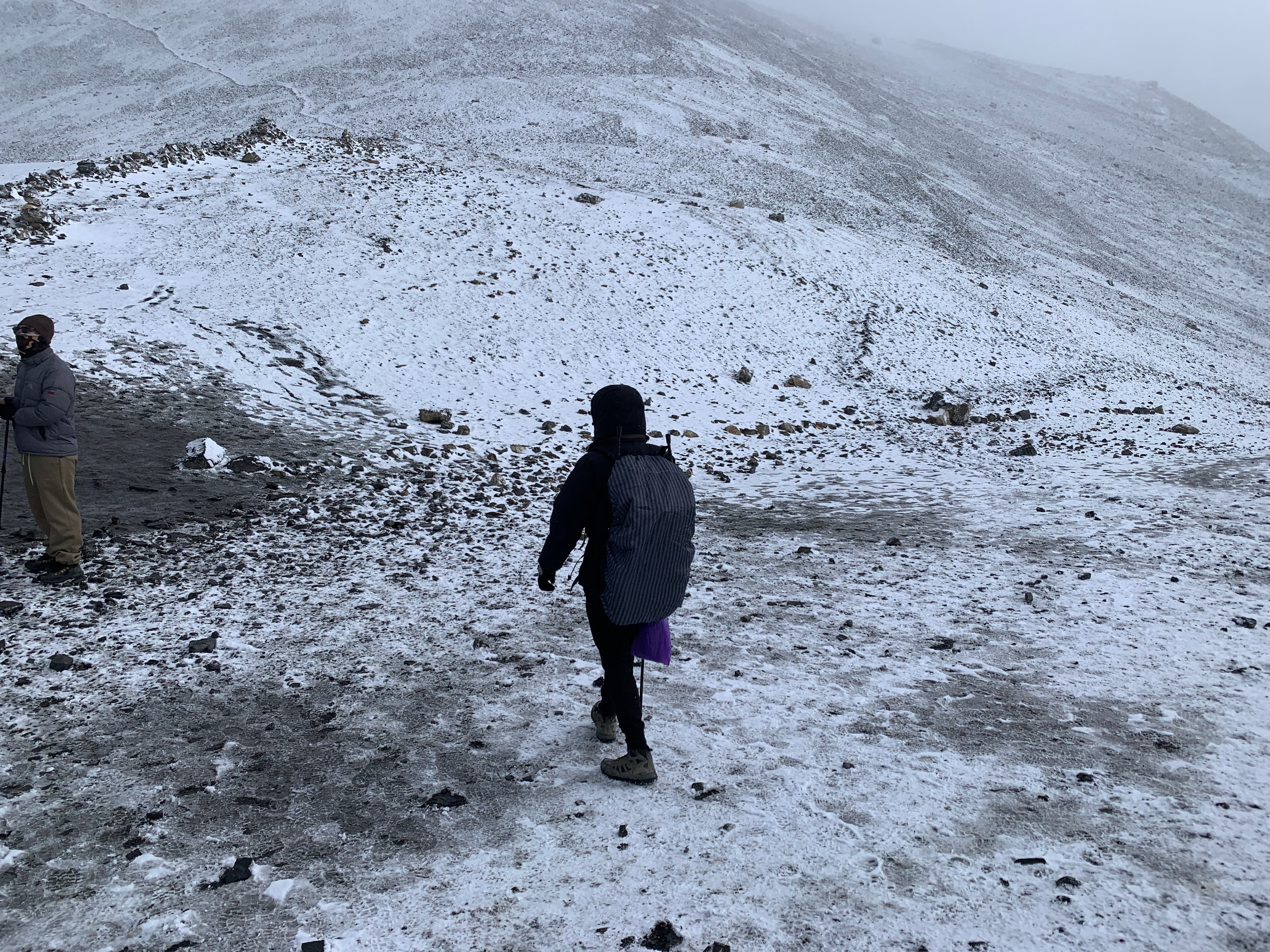 Standing on snowy pass with arms out