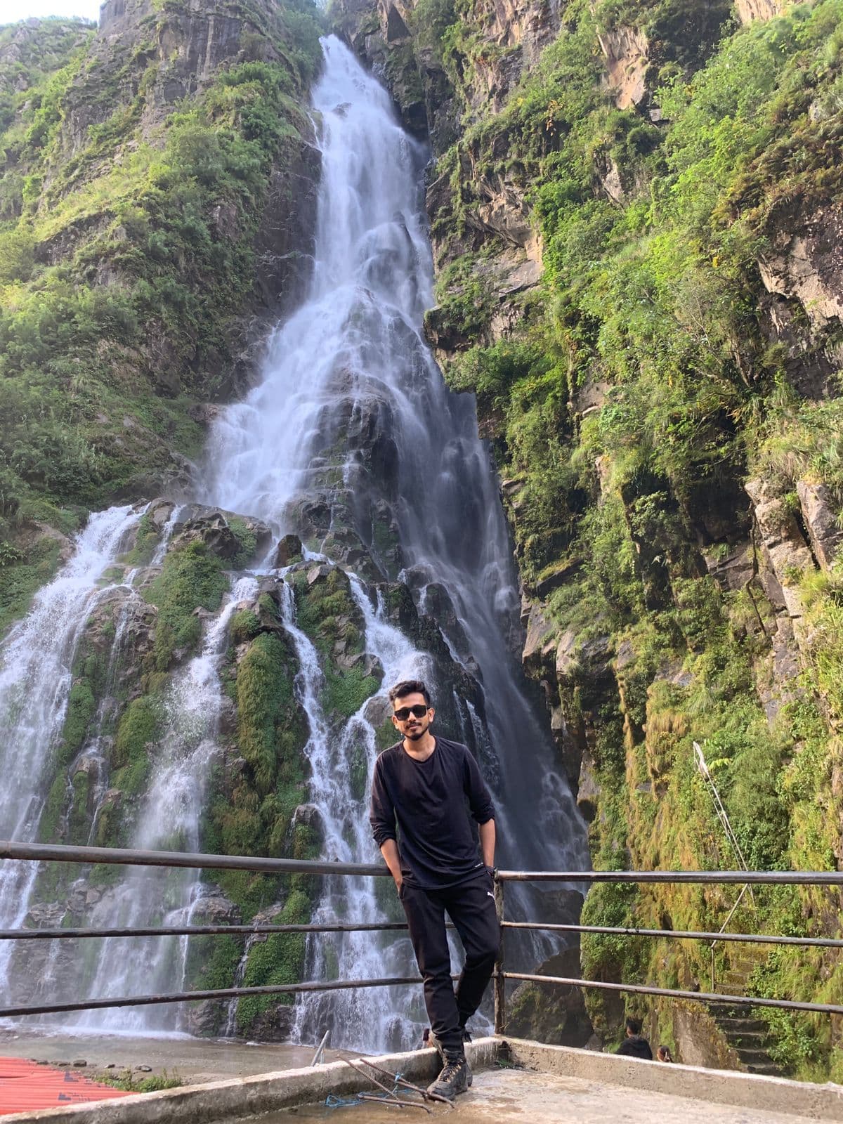 Huge waterfall with trekkers